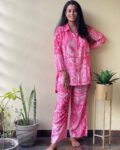 Woman wearing a pink printed cotton co-ord set with floral and paisley design, ideal for loungewear or casual daywear.