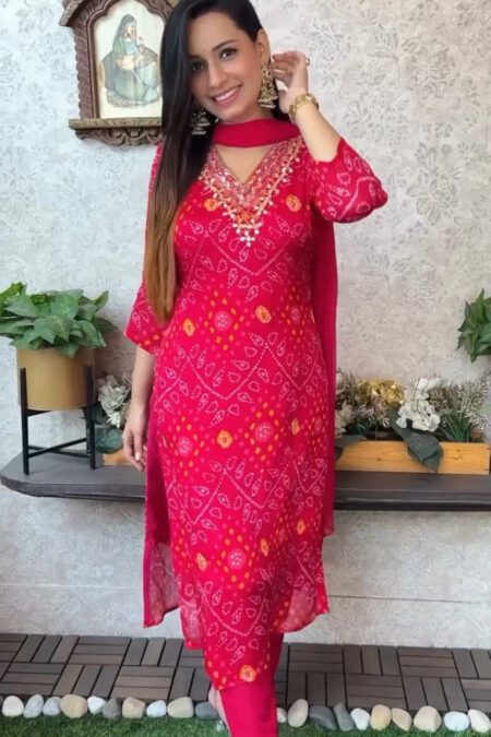 Woman wearing elegant red Bandhani kurta pant set with mirror work embroidery and matching dupatta – festive ethnic outfit for women.