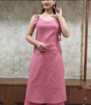 “Woman wearing pink sleeveless cotton kurti set with tie-up shoulder detailing, paired with matching pants, perfect for stylish summer ethnic wear.”