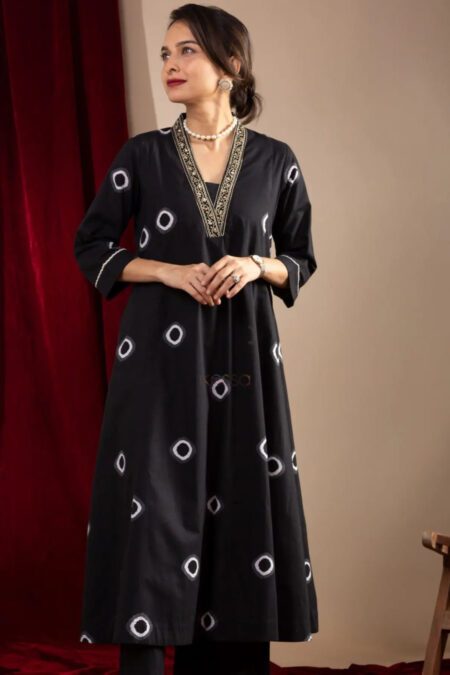 Woman wearing elegant black embroidered cotton kurta pant set with festive neckline design – perfect for office and traditional wear.