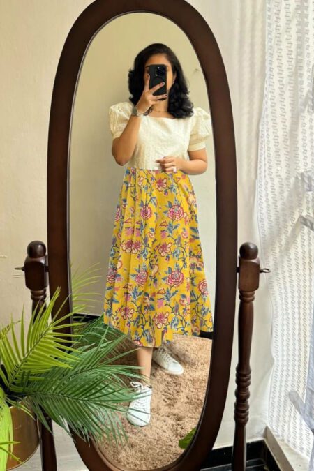 “Yellow floral midi dress for women with ivory puff-sleeve top and vibrant printed skirt”