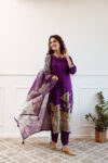 Woman wearing a purple floral printed kurti set with matching pants and dupatta, perfect ethnic wear for women.