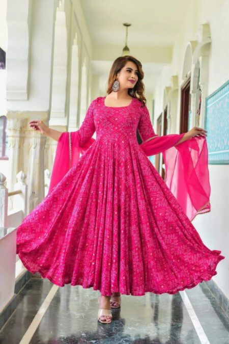Woman wearing pink Bandhani Anarkali kurta pant set with attached dupatta, perfect for festive occasions and ethnic functions.