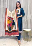 Woman wearing a teal blue kurta pant set with an artistic printed dupatta, posing indoors in a stylish ethnic outfit perfect for traditional occasions.