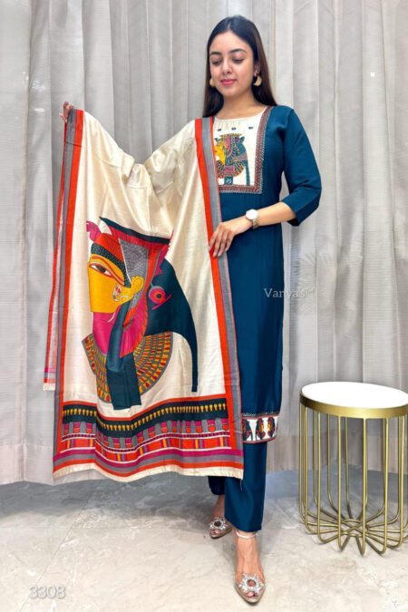 Woman wearing a teal blue kurta pant set with an artistic printed dupatta, posing indoors in a stylish ethnic outfit perfect for traditional occasions.