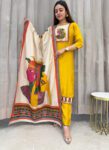 Woman wearing a yellow kurta pant set with an artistic printed silk dupatta, standing against a curtain background in an ethnic outfit perfect for festive or casual wear.