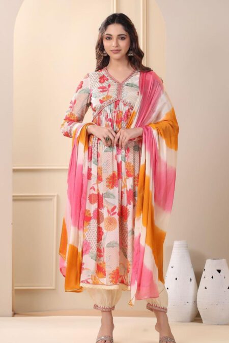 Woman wearing a floral printed kurta pant set with a pink and orange tie-dye dupatta, perfect for festive and ethnic occasions.
