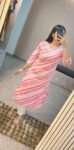 “Woman wearing a pink and white striped cotton kurti with embroidered neckline, perfect for daily summer wear”