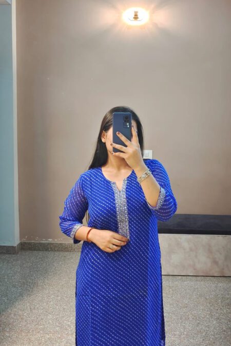 Woman wearing a royal blue Bandhani cotton kurti with embroidered neckline, perfect for ethnic wear and daily styling.