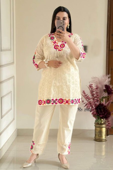 “Women’s cream embroidered co-ord set with kurta and straight pants featuring colorful cutwork detailing”