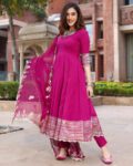“Magenta Anarkali kurta set for women with golden border, matching pants, and embroidered dupatta – festive ethnic wear”
