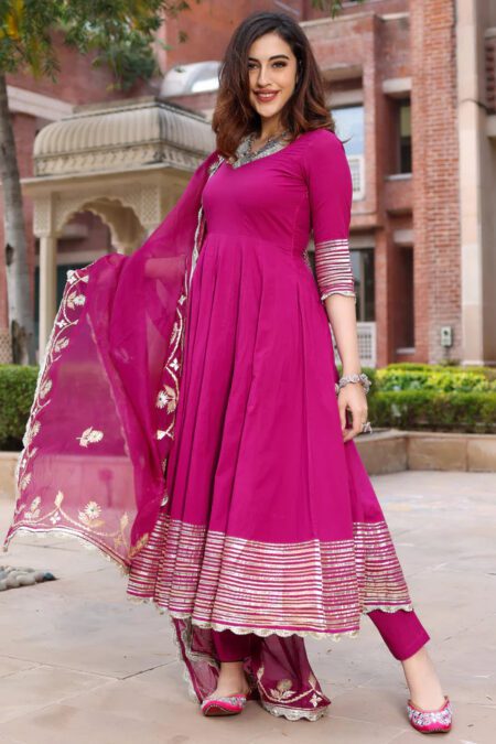 “Magenta Anarkali kurta set for women with golden border, matching pants, and embroidered dupatta – festive ethnic wear”
