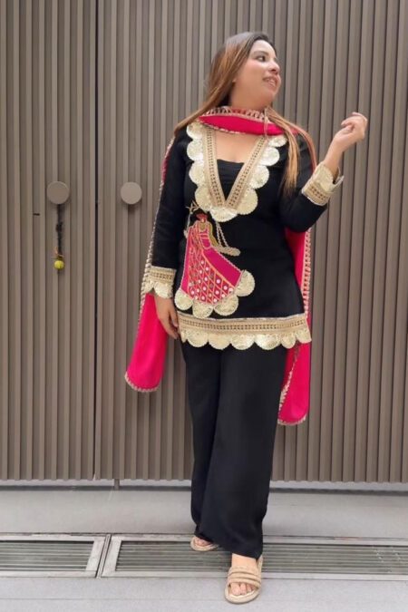 “Black embroidered kurta set for women with golden lace detailing, pink dupatta, and matching pants – festive party wear outfit”